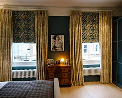 master bedroom with designer curtains and traditional chest of drawers