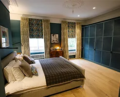 large modern bedroom with stylised fitted sliding wardrobe
