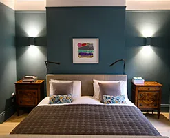 master bedroom with matching bedside tables and contemporary lighting