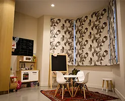 children's eating area with modern furniture and patterned blinds
