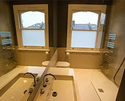 modern shower room with large sash windows