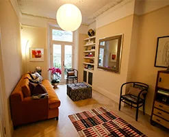 spacious home sitting room illuminated by a large bulbous pendant lamp