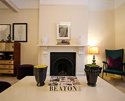 home fireplace featuring a traditional mantlepiece and furnished living space