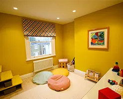 playroom with abstract art and roman blinds