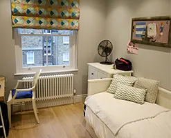 home bedroom with workspace and decorative blinds